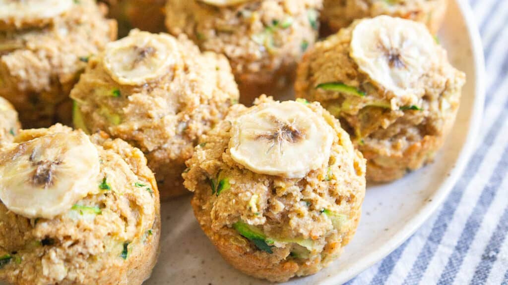 Mini banana zucchini muffins on a plate.