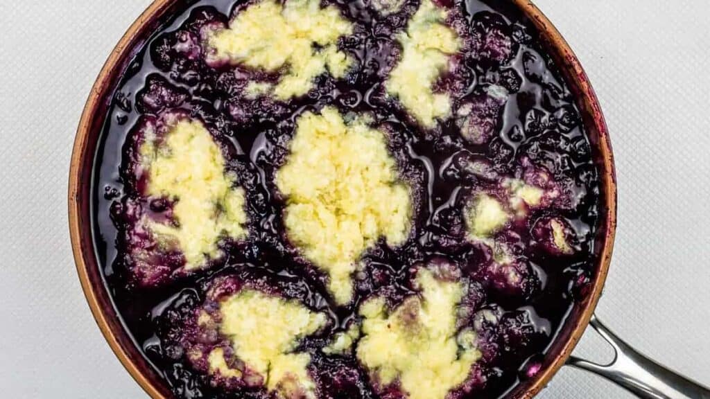 A homemade blueberry grunt in a pan.