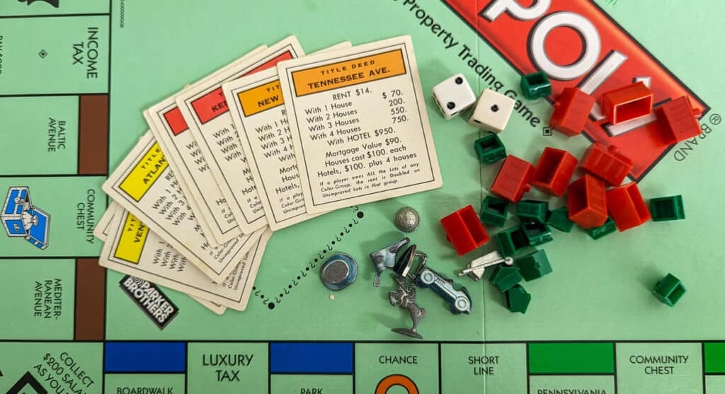 Monopoly board with property cards, pieces, hotels and houses.