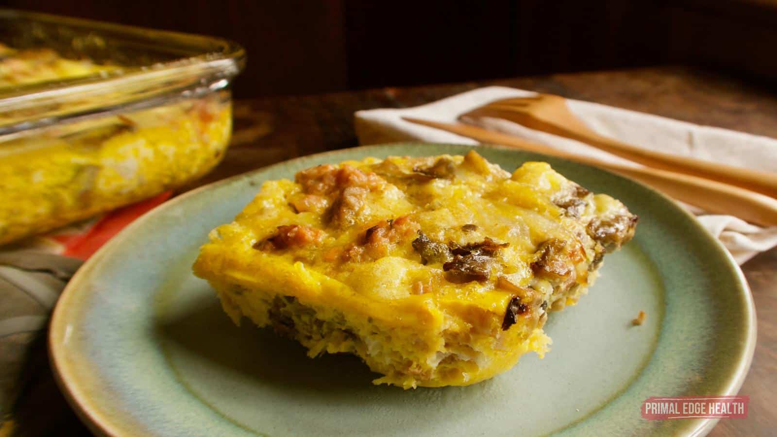 A picture of a portion of keto breakfast casserole on light blue plate.