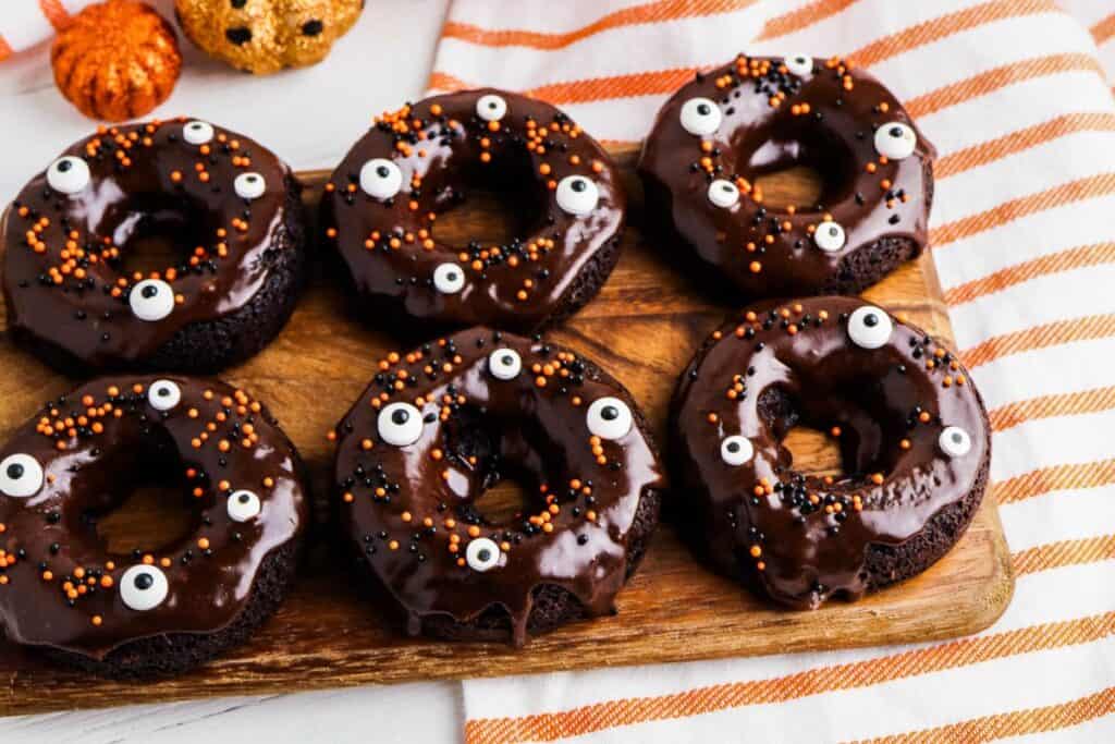 Chocolate Cake Mix Donuts decorated for halloween with frosting and sprinkles.