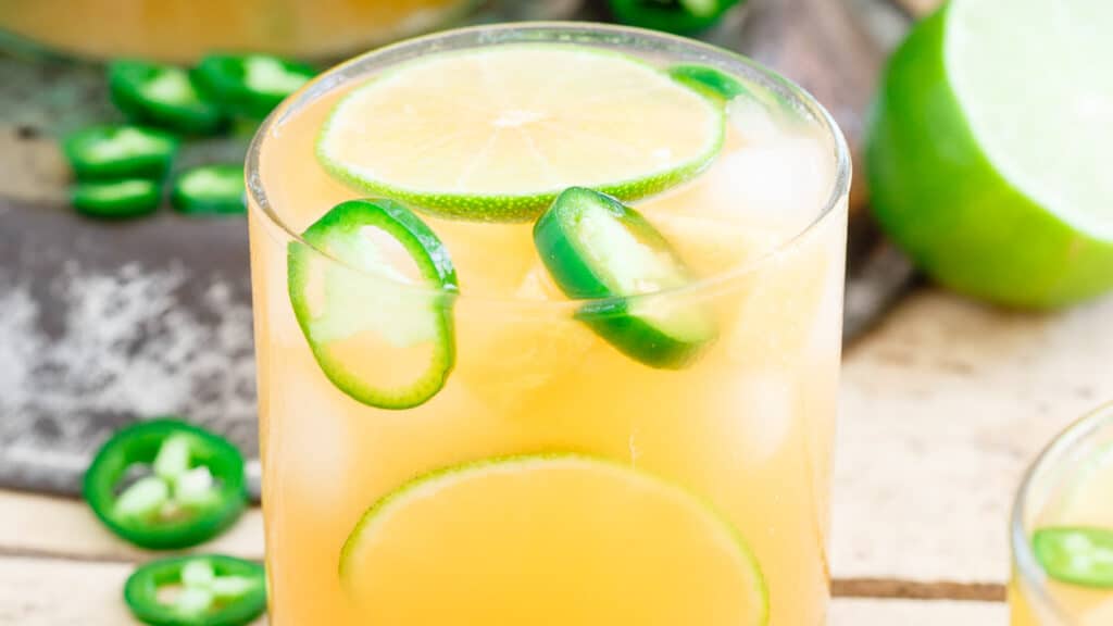 Cantaloupe lime jalapeño agua fresca in a glass.