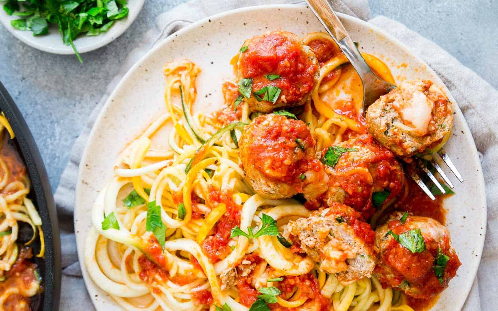 Cheddar stuffed turkey meatballs served with zoodles.