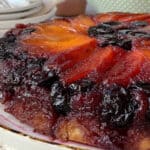 Cherry apricot upside down cake on a white platter.