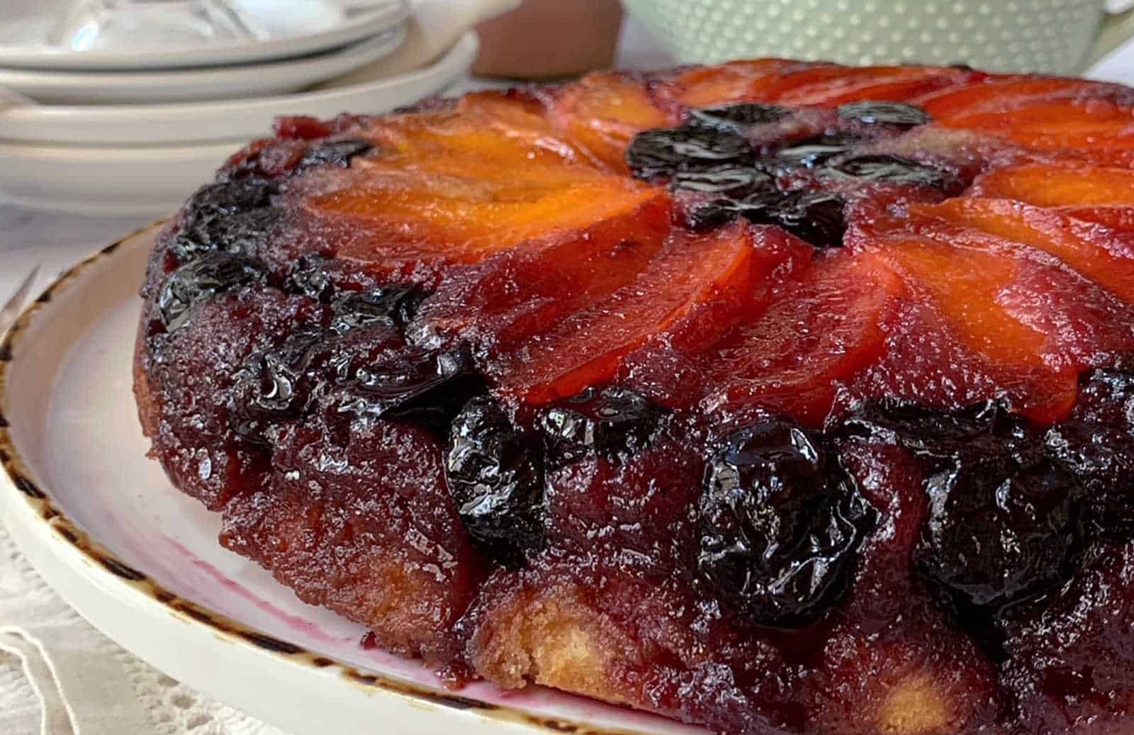 Cherry apricot upside down cake on a white platter.