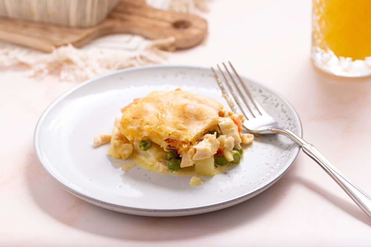 Small serving of chicken pot pie casserole on plate with fork.
