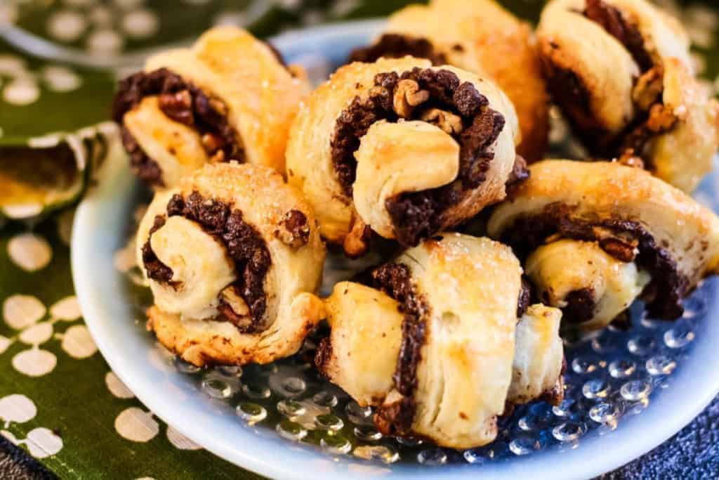 low angle shot of rugelach cookies filled with chocolate and pecans.