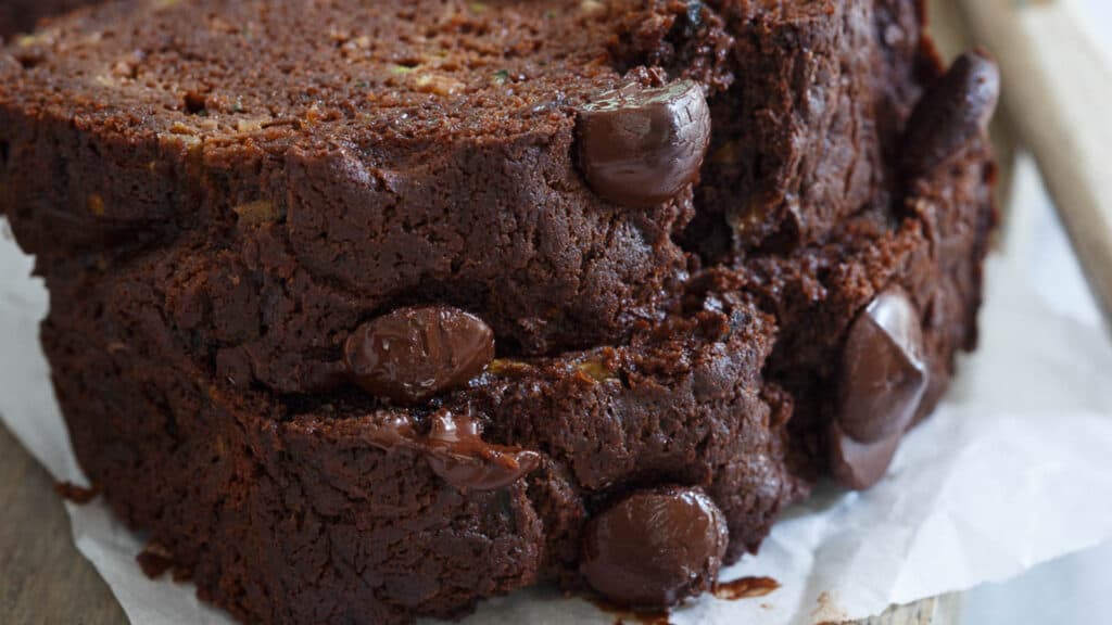 Chocolate zucchini bread slices stacked on top of each other.