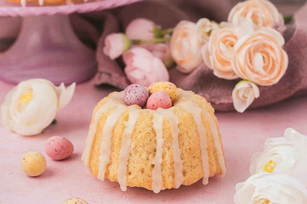 A mini bundt cake with chocolate mini eggs on top. 