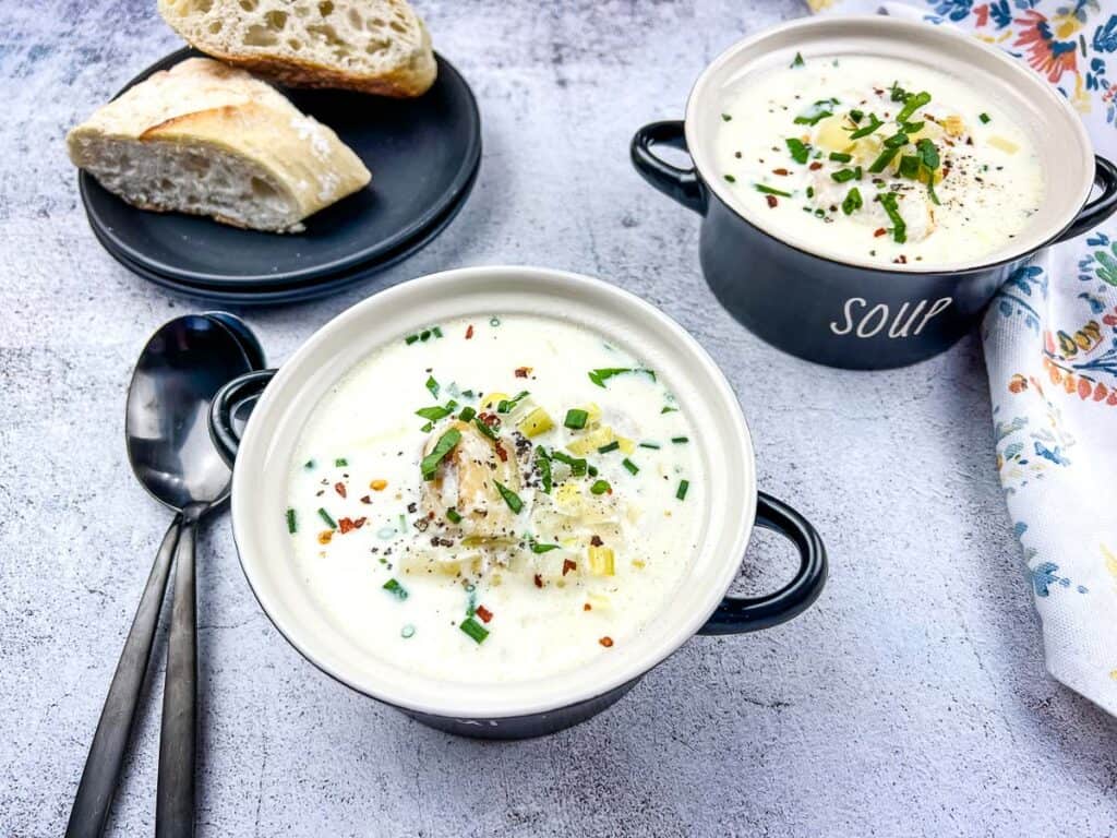 Cullen Skink in two bowls with crusty bread in the background