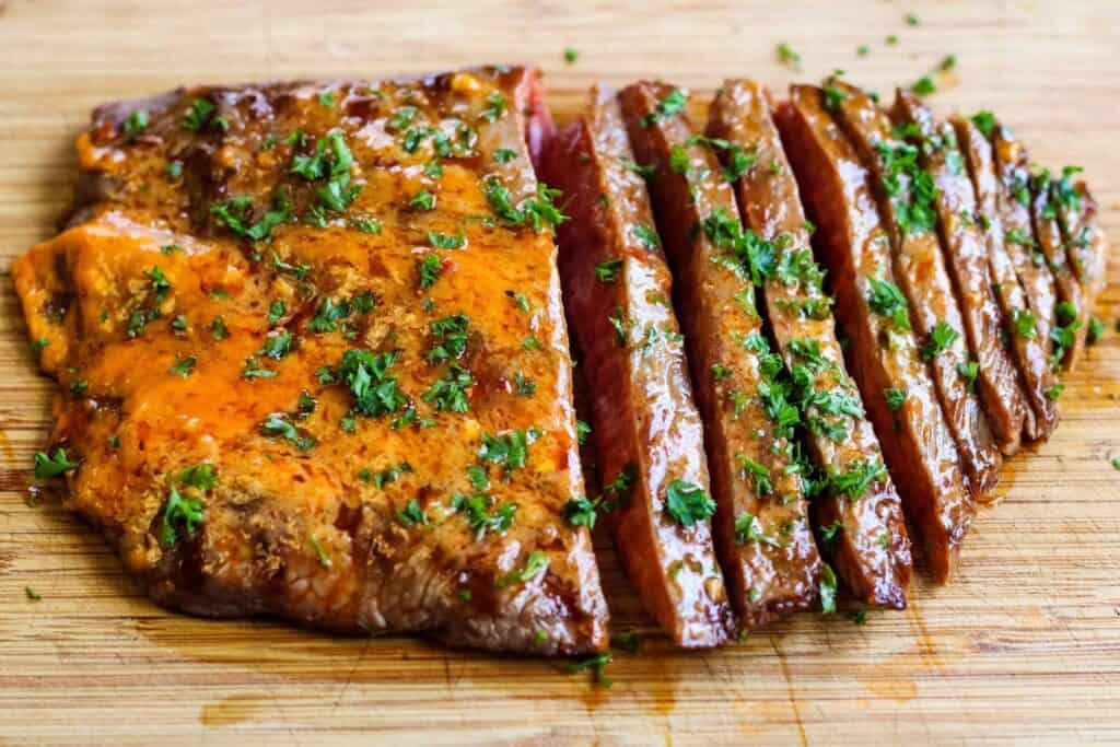 Sliced flank steak with chili butter.