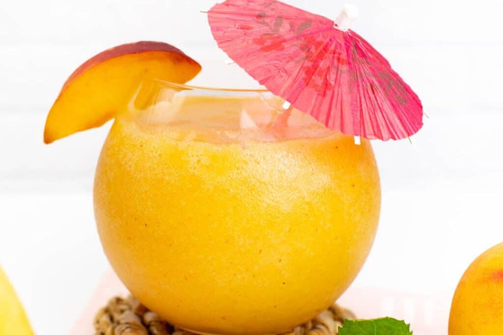 frozen peach daiquiri with umbrella.