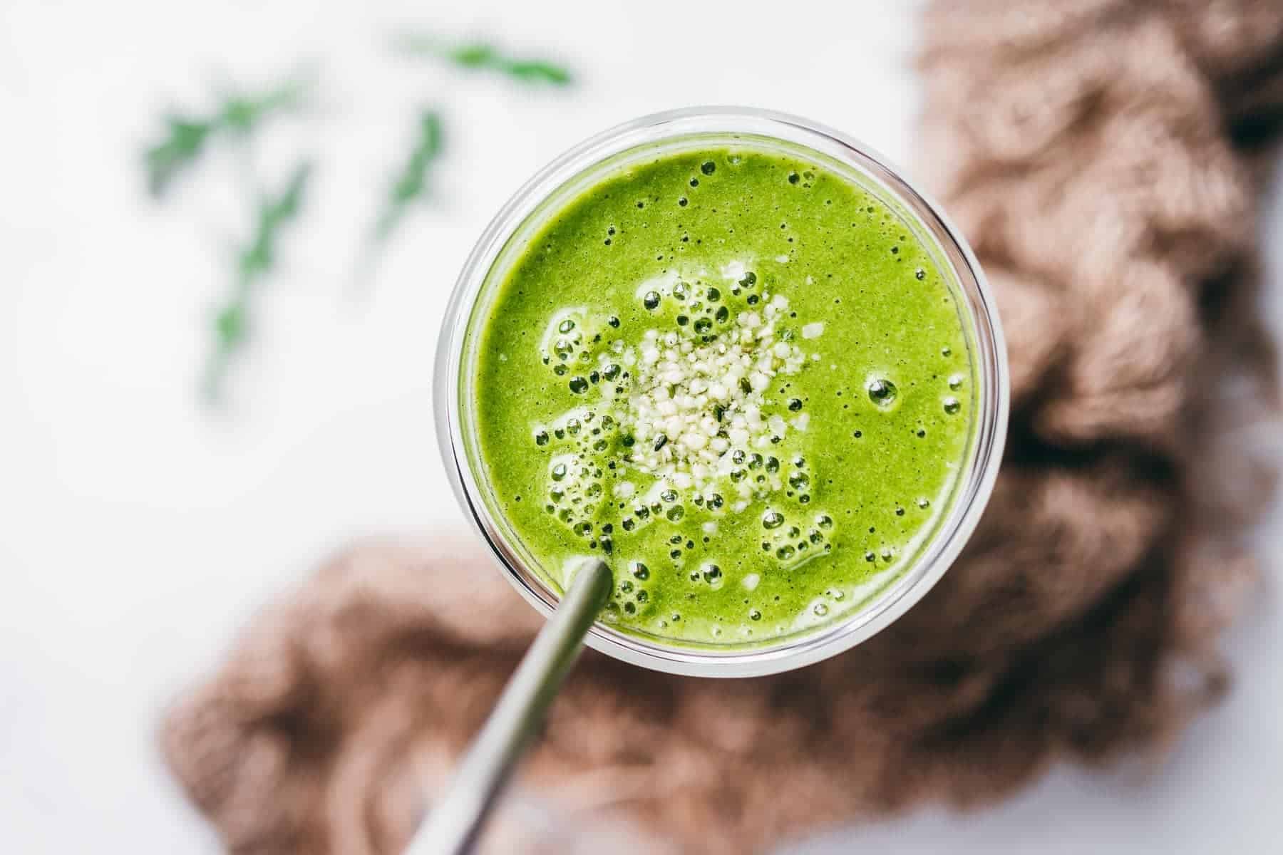 Green smoothie with a spoon.