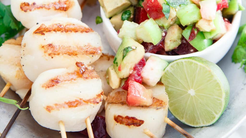 Grilled scallop skewers with plum tomatillo salsa.
