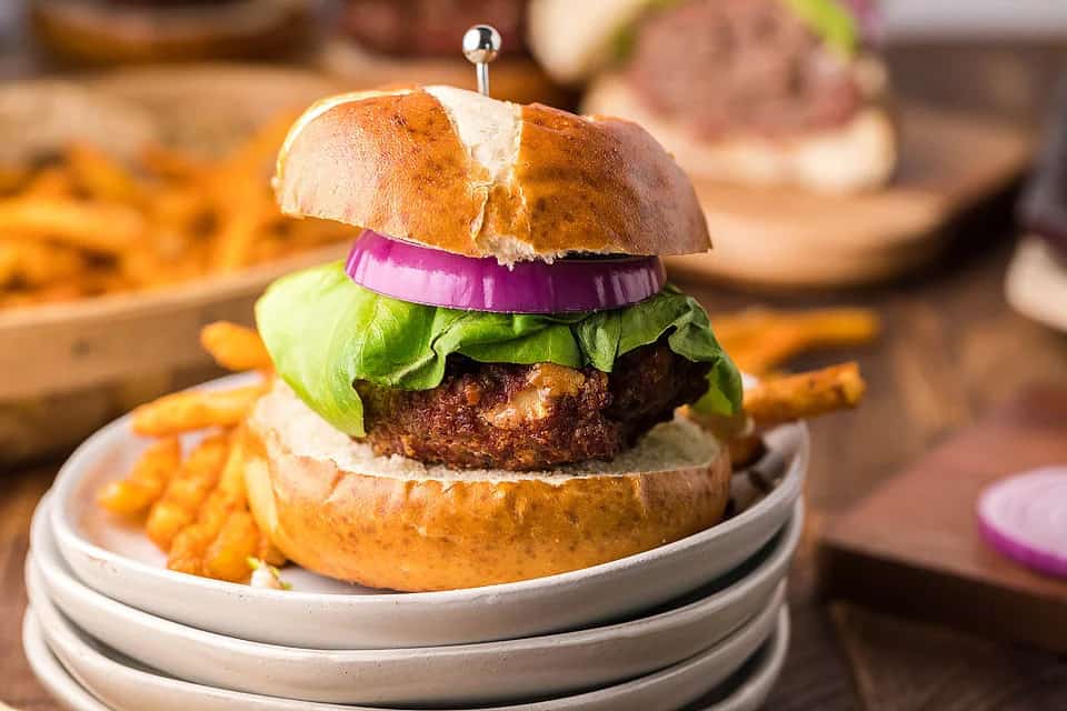 A homemade burger on a white plate.