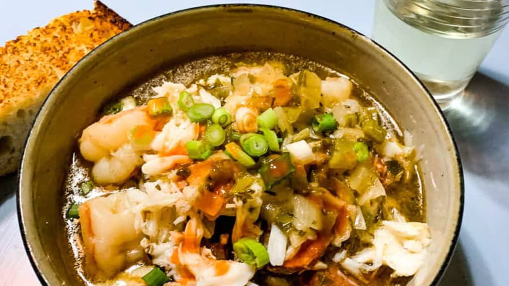 Crab, shrimp, and sausage gumbo in a bowl.