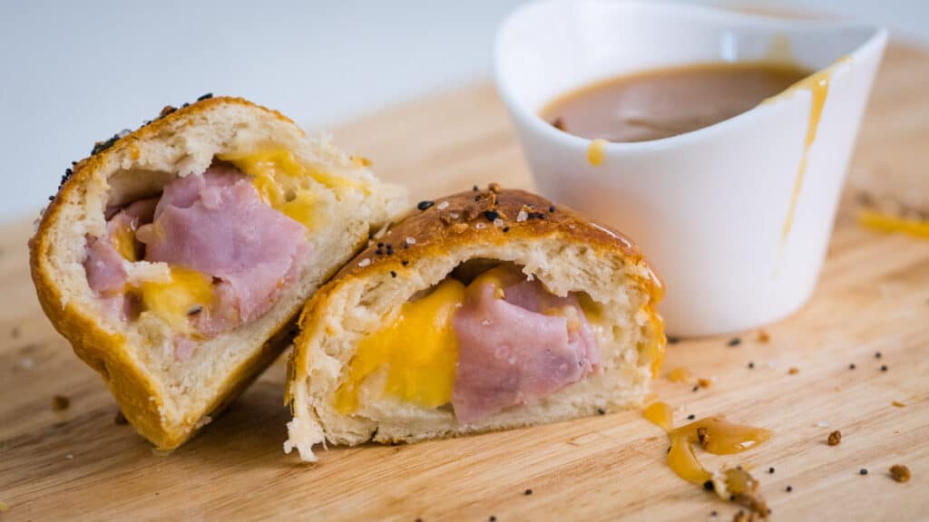ham and cheese biscuits cut in half with mustard dipping sauce.