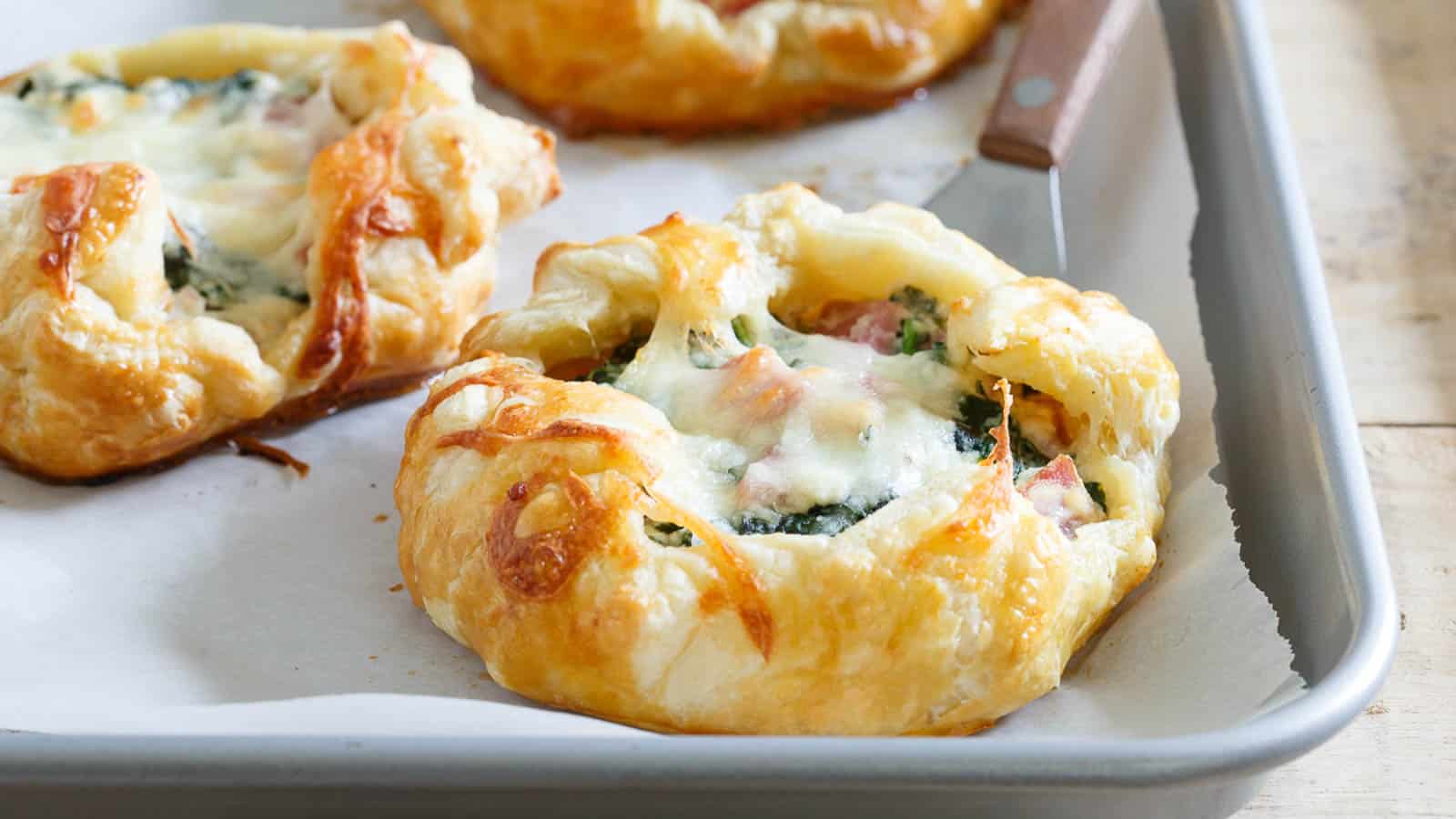 https://tastesdelicious.com/wp-content/uploads/2023/12/ham-cheese-spinach-breakfast-pies-1.jpg