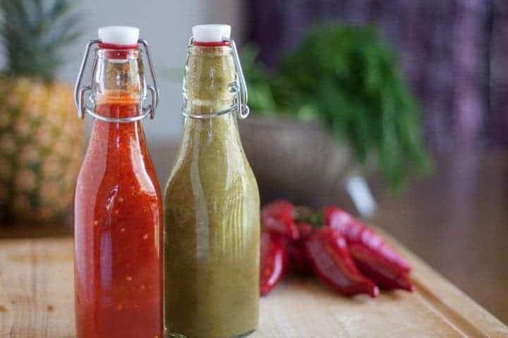 Bottled homemade hot sauce--one red and one green.
