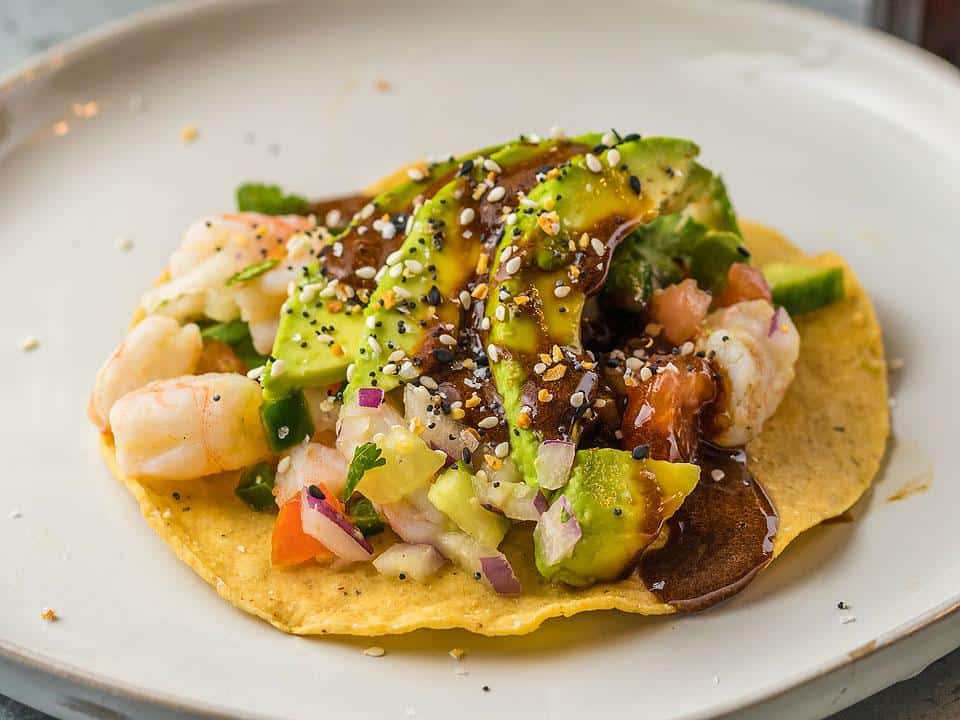 A seafood taco with homemade unagi sauce drizzled on top. 