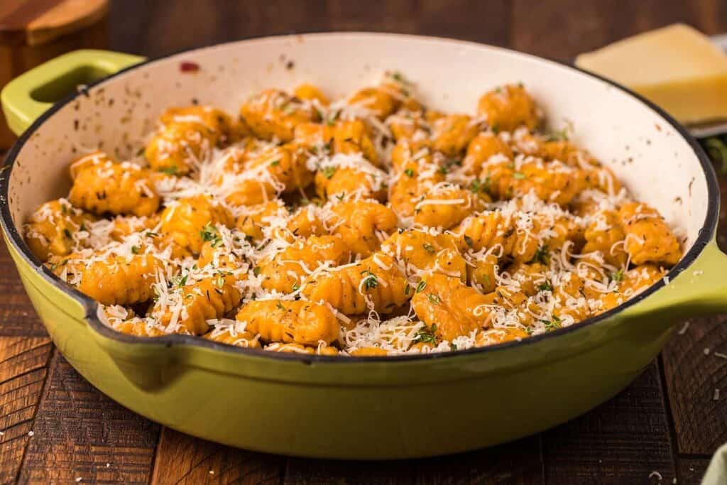 Gnocchi made from sweet potatoes served from a cast iron skillet.