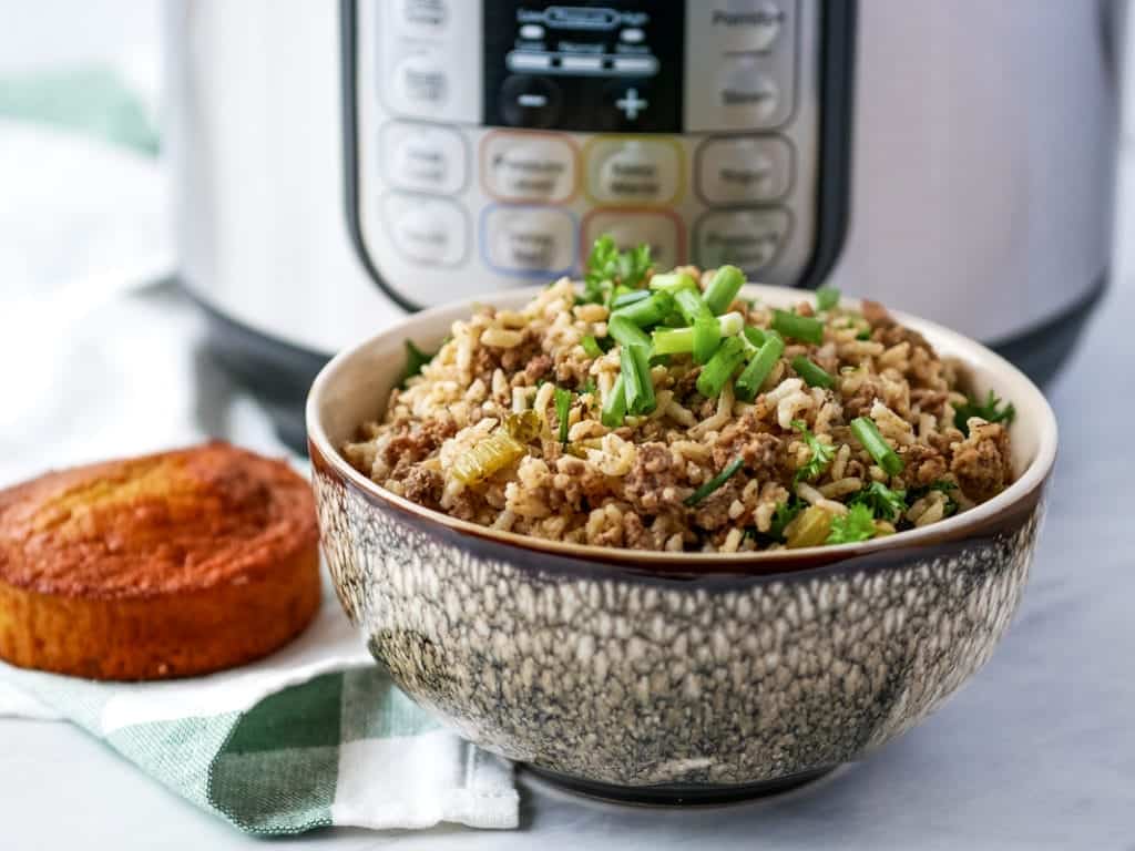 Instant Pot Dirty Rice in ceramic bowl with green onion