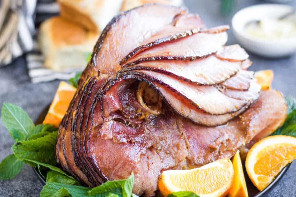 Sliced ham with oranges and mint.