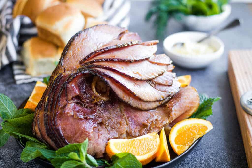 Sliced ham with oranges and mint.