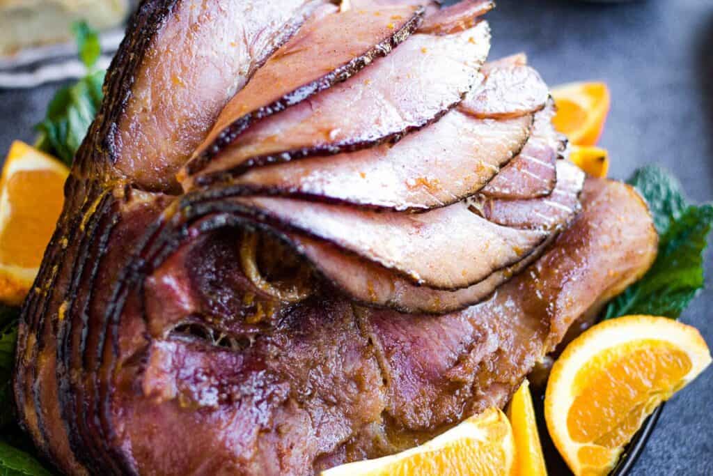 Sliced ham with oranges and mint.