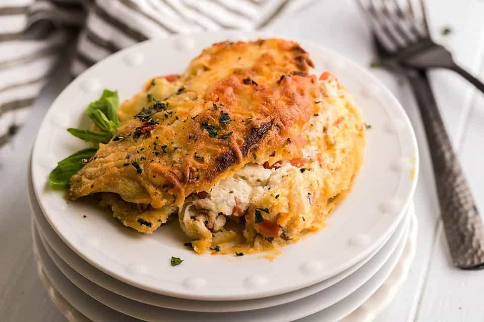 Chicken alfredo crepes on a plate.