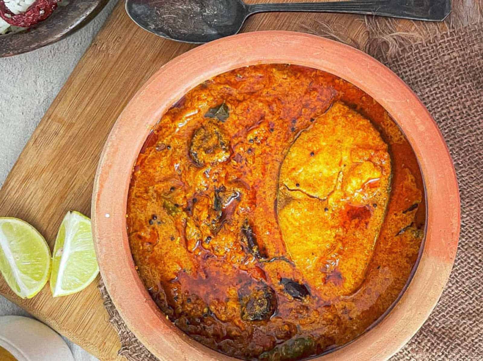 Fish curry in an earthenware baking dish.