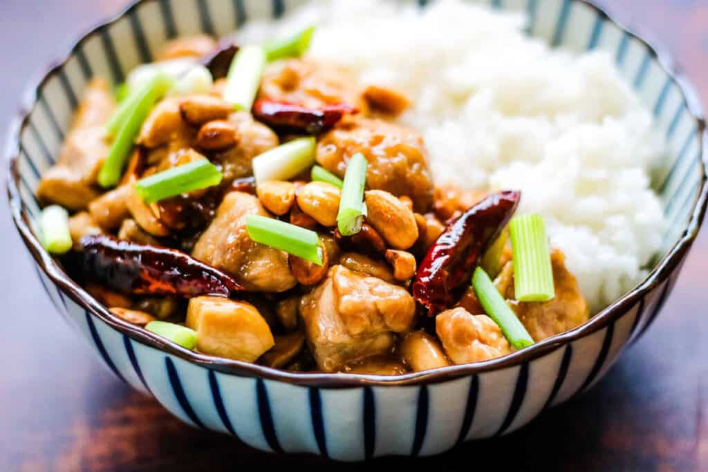 low angle shot of a bowl of kung pao chicken.