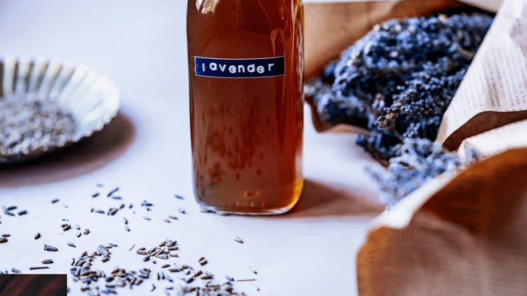 A glass bottle filled with a lavender simple syrup.