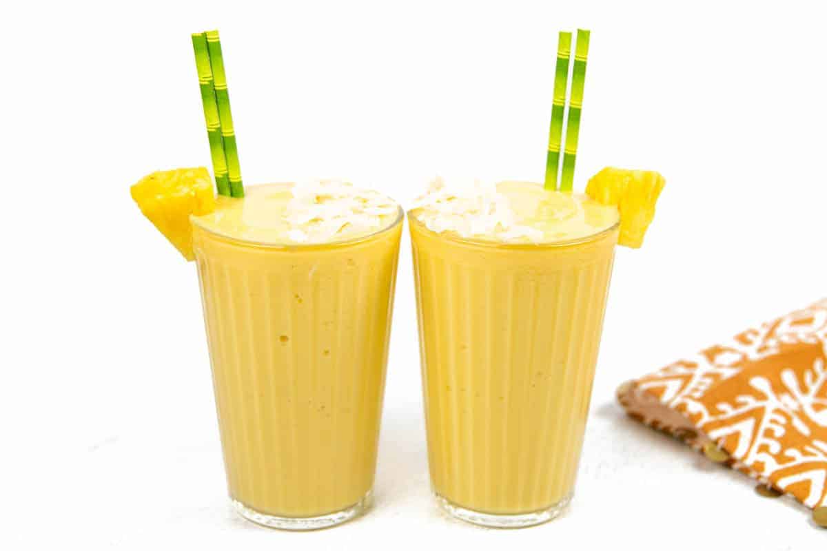 Two pineapple mango smoothies side by side.