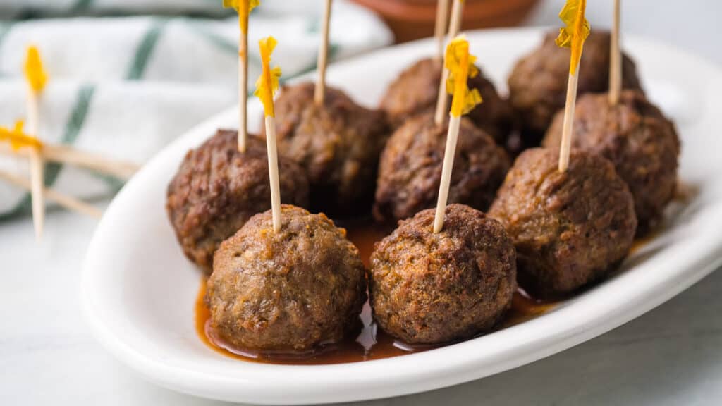 plate of frozen meatballs with toothpicks sticking out of them.