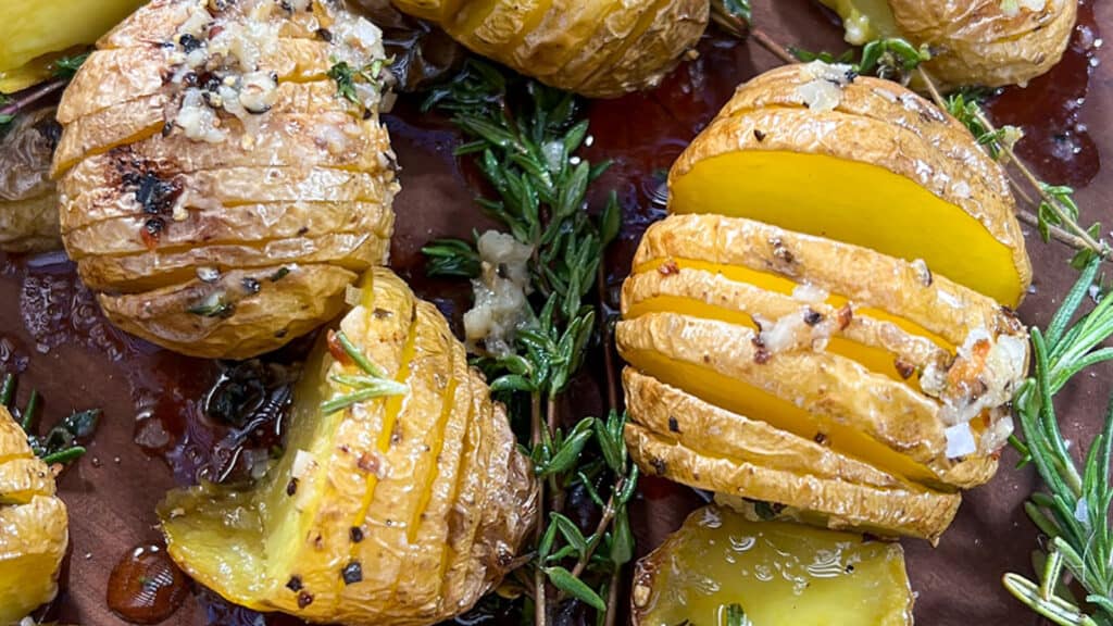 Grilled Mini Hasselback Potatoes with fresh herbs.
