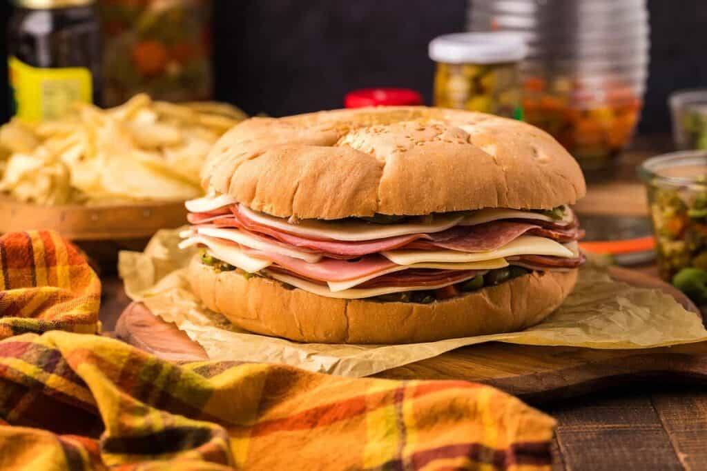A homemade muffaletta sandwich on a table.