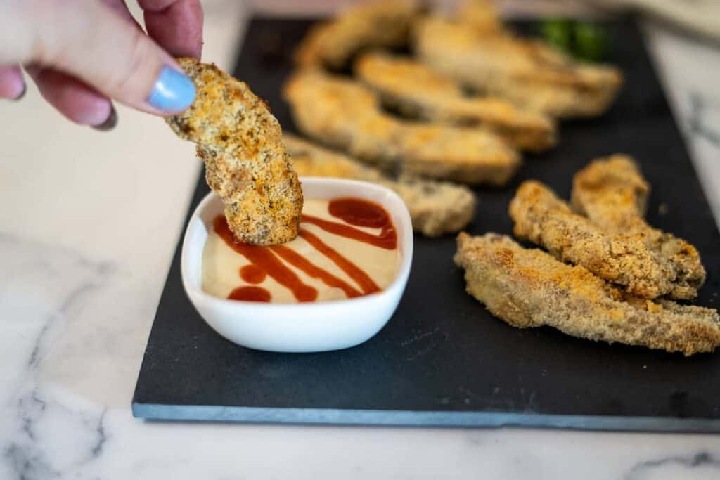 Air fried portobello mushrooms on a plate with a dip