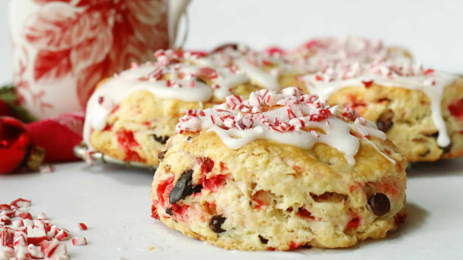 Chocolate and peppermint scones with icing and peppermint candies.