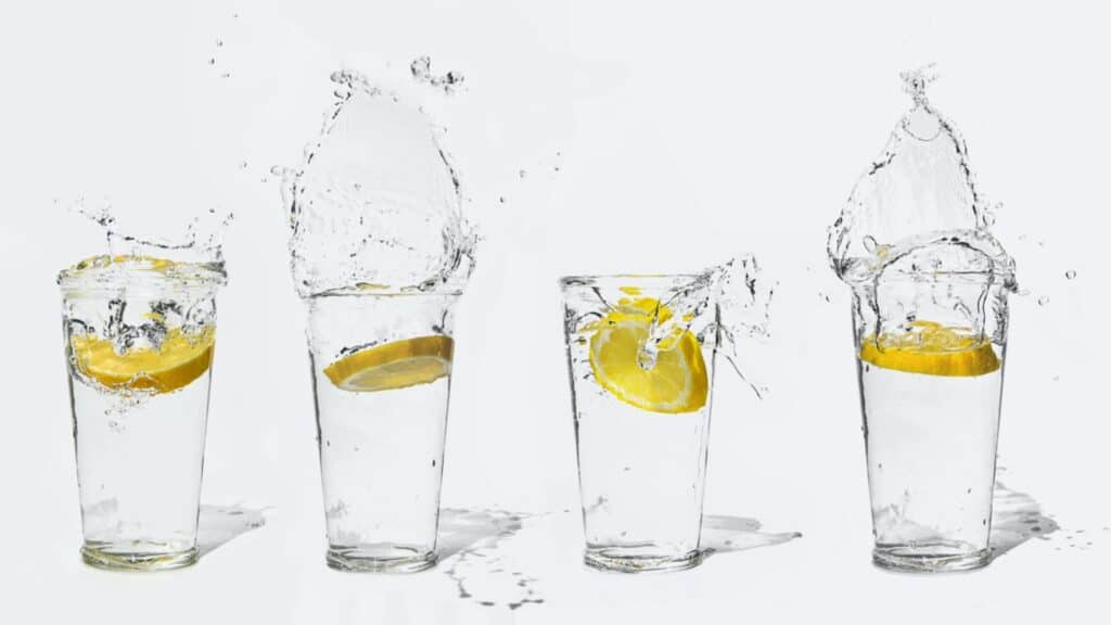 Glasses filled with water and slices of lemons dropped in. 