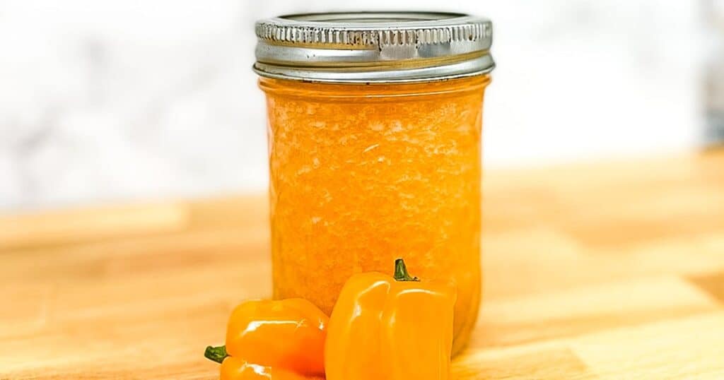 pineapple habanero sauce in a glass jar with a lid.