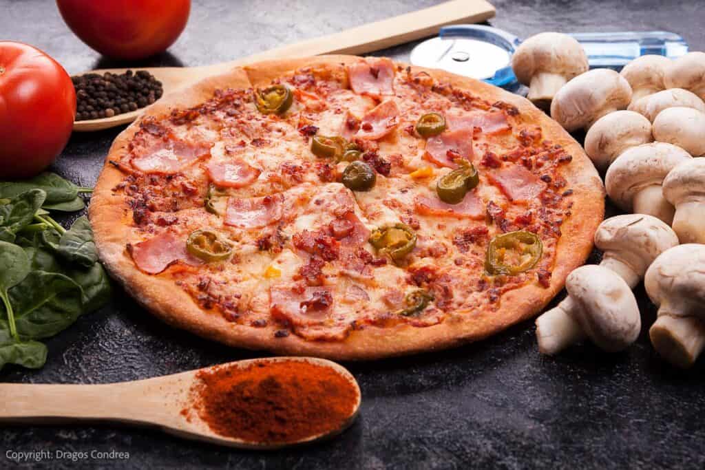 pizza with tomato sauce, mushrooms, and olives.