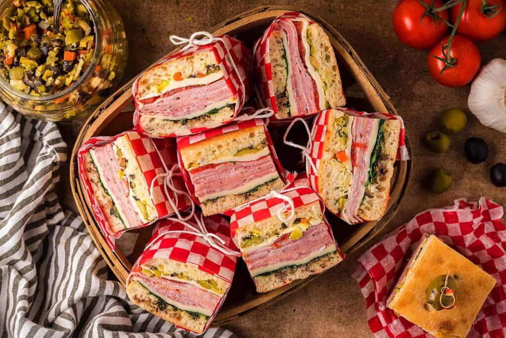 Overhead view of a basket of pressed Italian sandwiches.