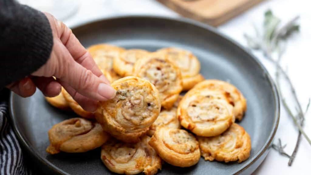 Puff pastry pinwheels on a brown platter.
