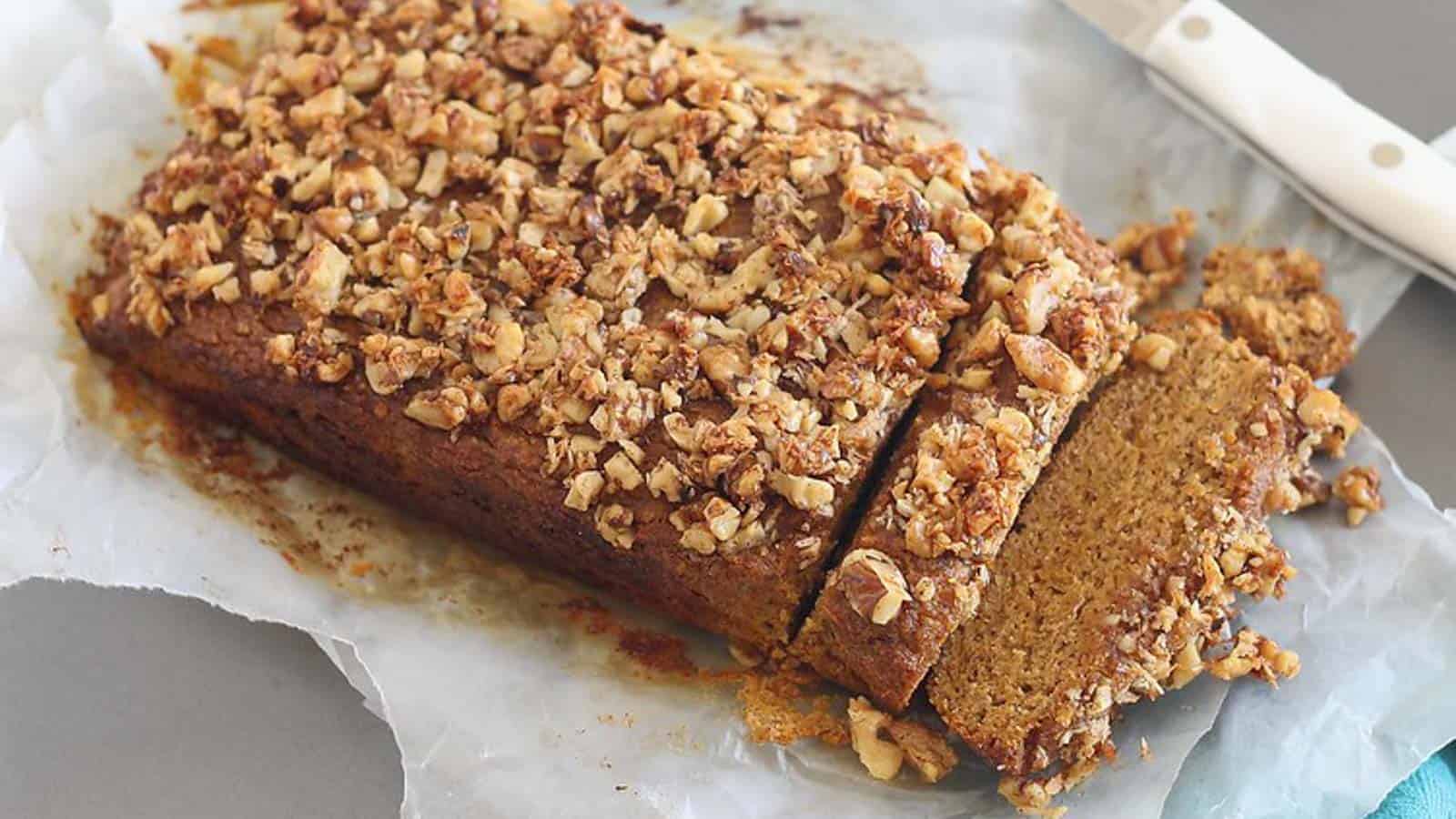 A slice of pumpkin bread with granola on top.