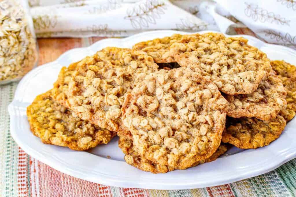 Low angle shot of oatmeal cookies on a white plate.