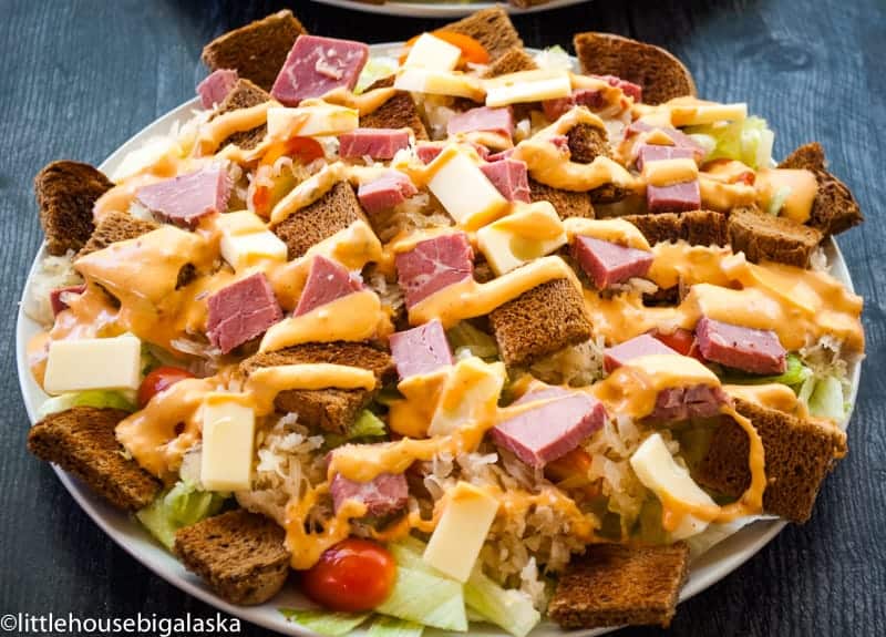 Salad with corned beef, cheese, sauerkraut, dressing and rye bread cubes.