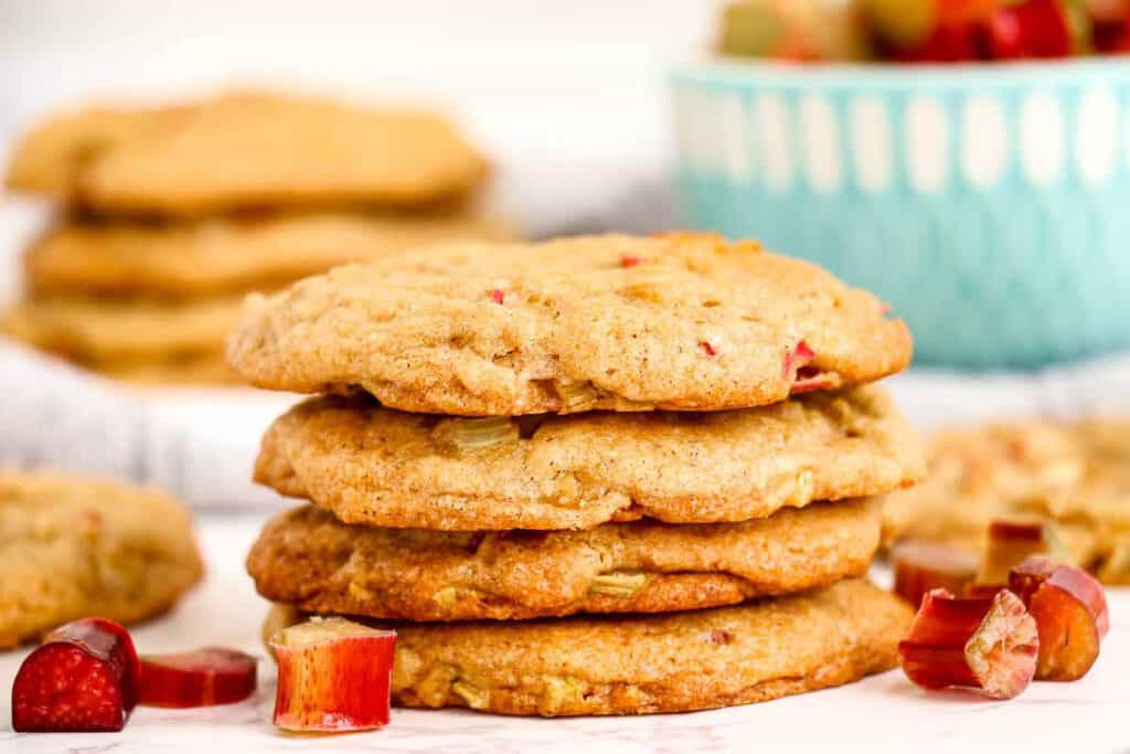 stacked rhubarb cookies with slices of rhubarb.