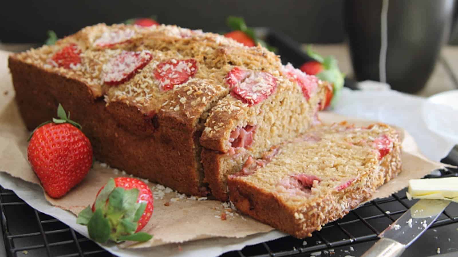 Roasted strawberry coconut yogurt bread with two slices cut.