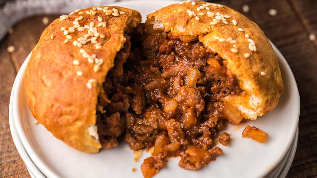 A biscuit pocket with ground beef filling on a plate.